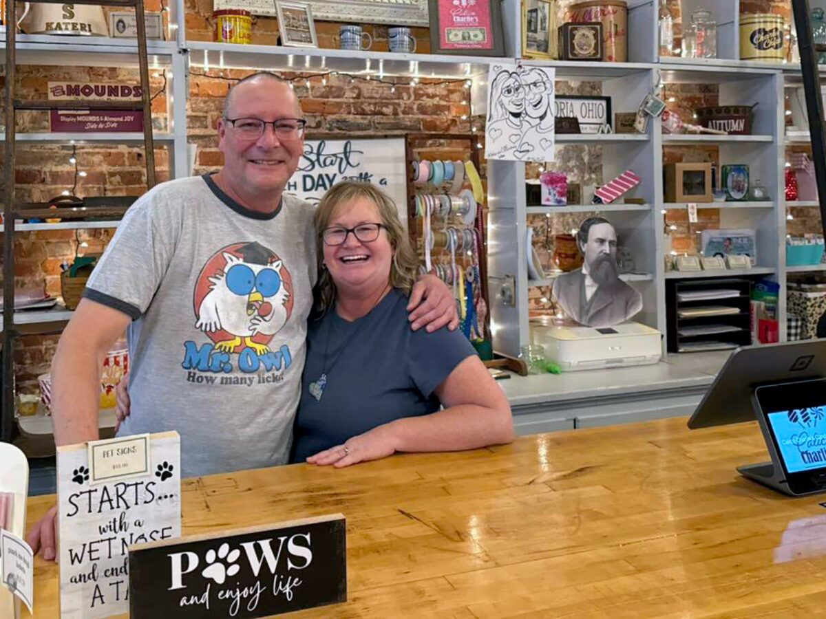 Kristin and Matt Koester inside their shop, surrounded by candy shelves and local gifts